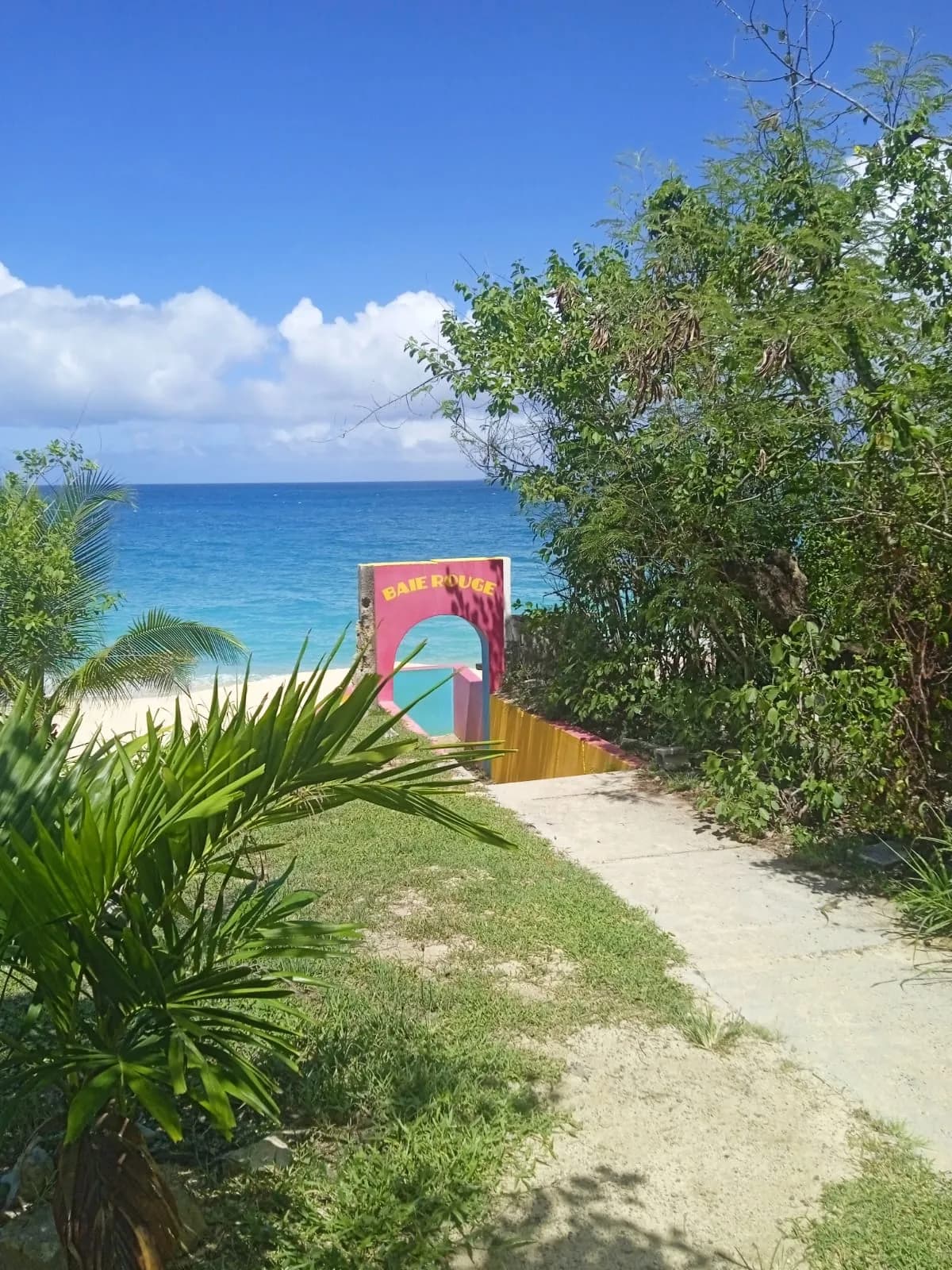 Colorful entrance to Baie Rouge beach on the French side