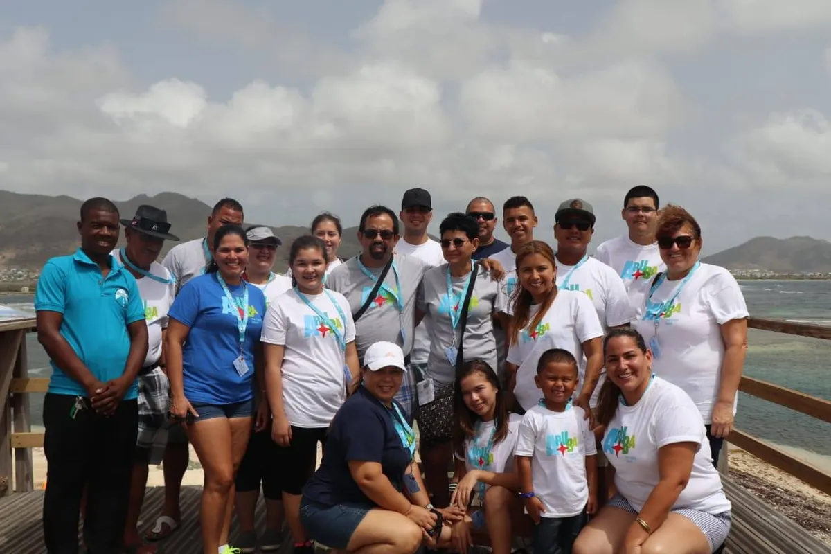 Tour group at oceanside boardwalk with harbor view