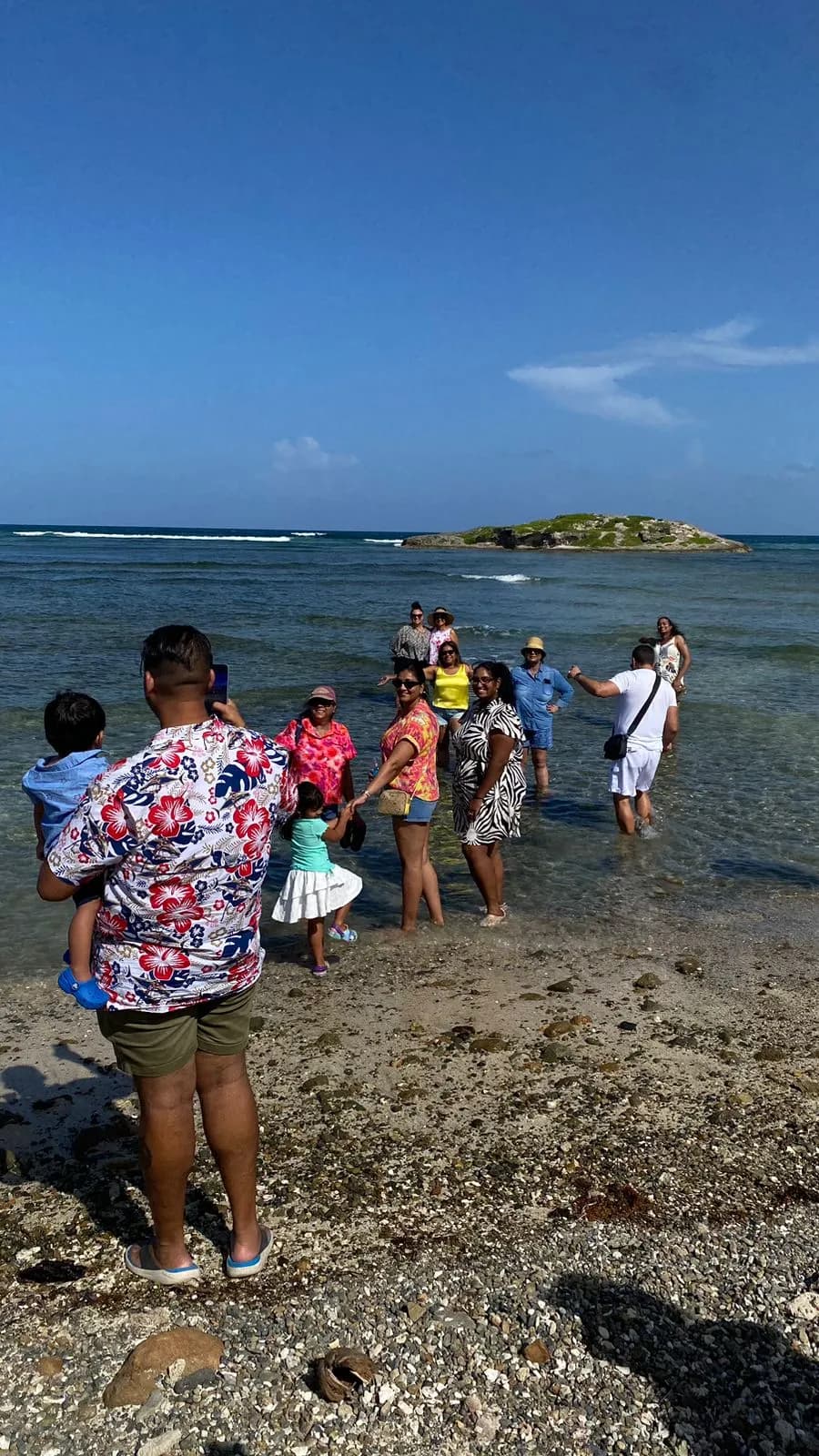 Confidence Tours guests wading in crystal-clear Caribbean water during a beach-hopping tour