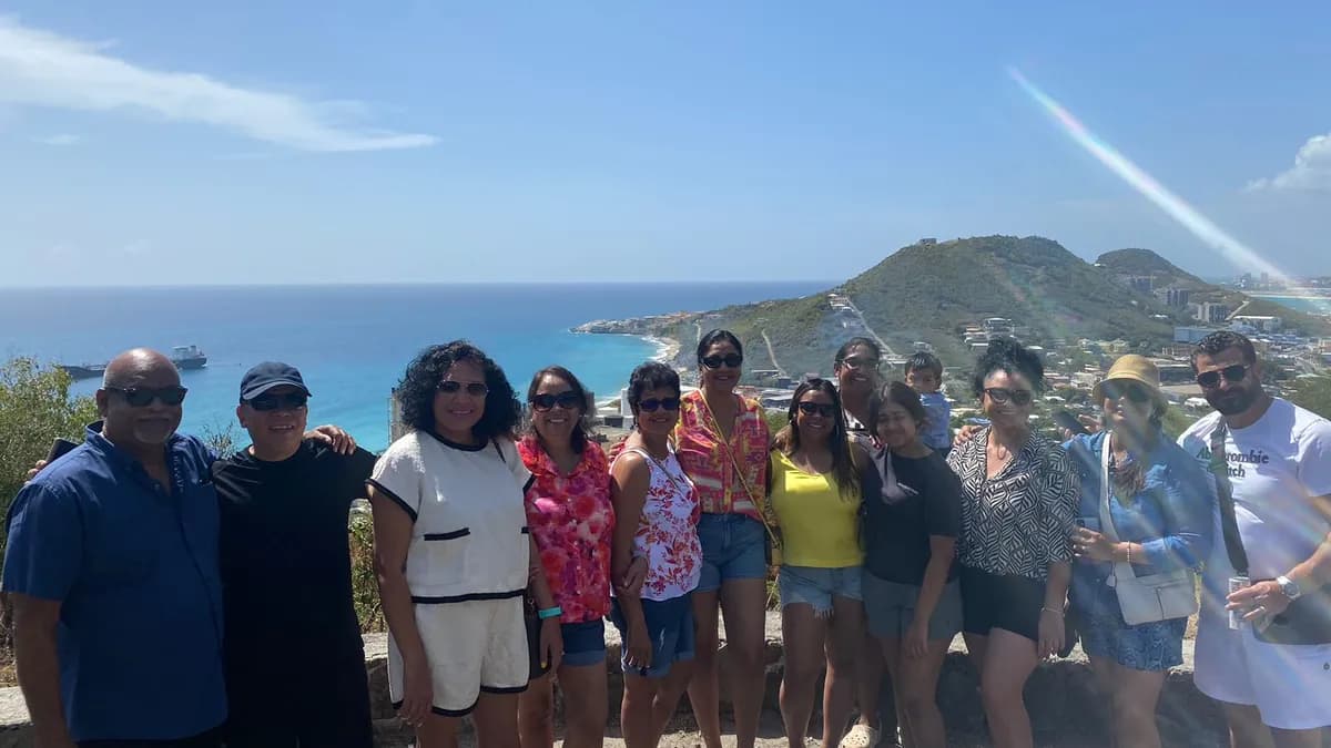 Confidence Tours group at a hilltop viewpoint overlooking St. Maarten coastline and turquoise bays