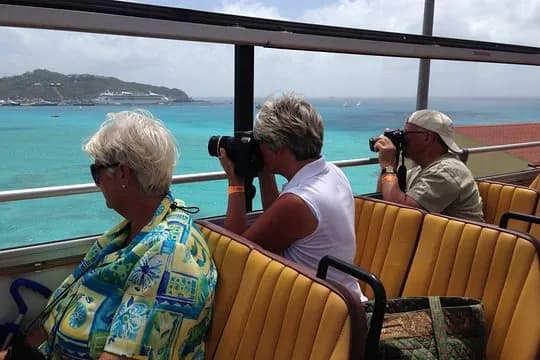 Cruise tourists photographing the turquoise Caribbean from a St. Maarten tour bus